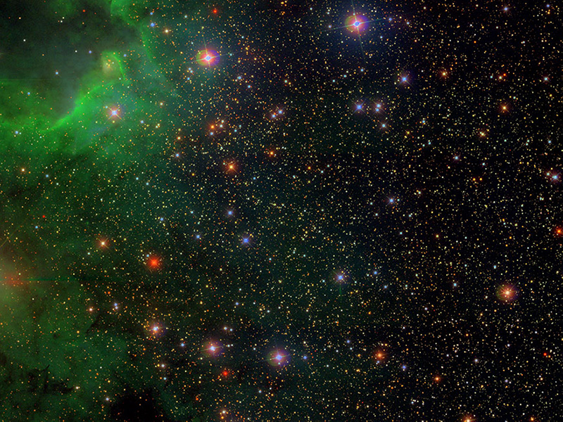 Star field with a green nebula