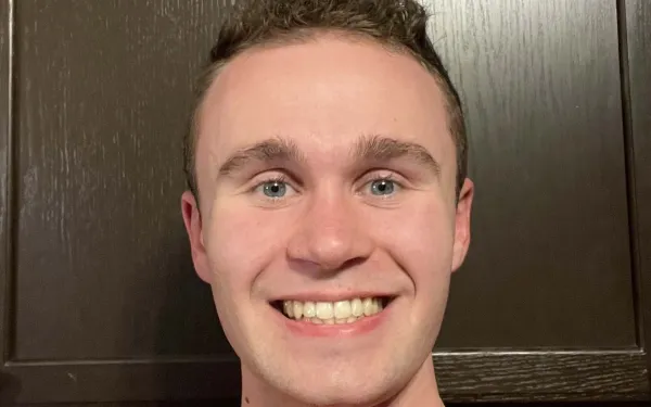 A smiling man with short hair