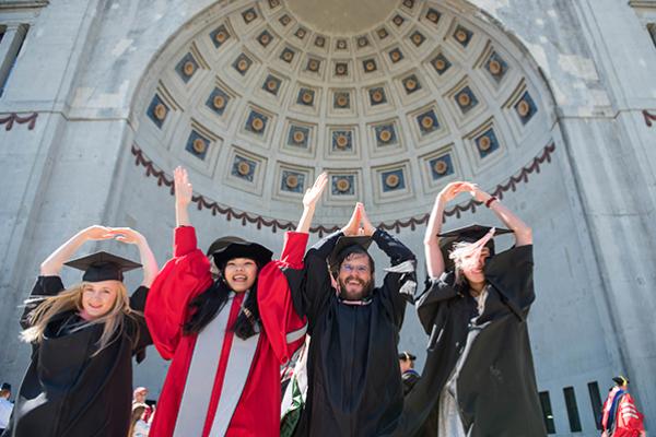 Students in graduate clothing doing O-H-I-O